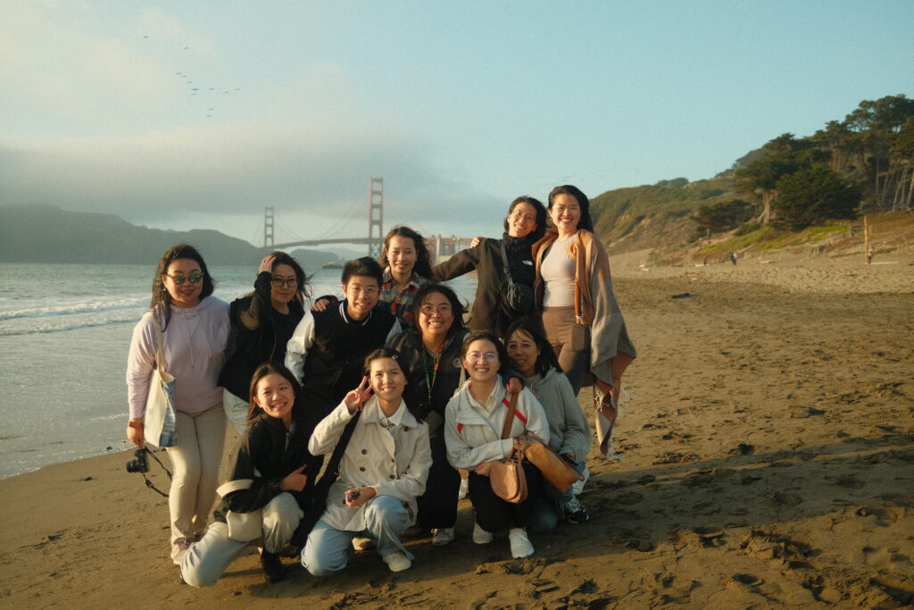 PFP Fellows stand together for a photograph on a beach in San Francisco.